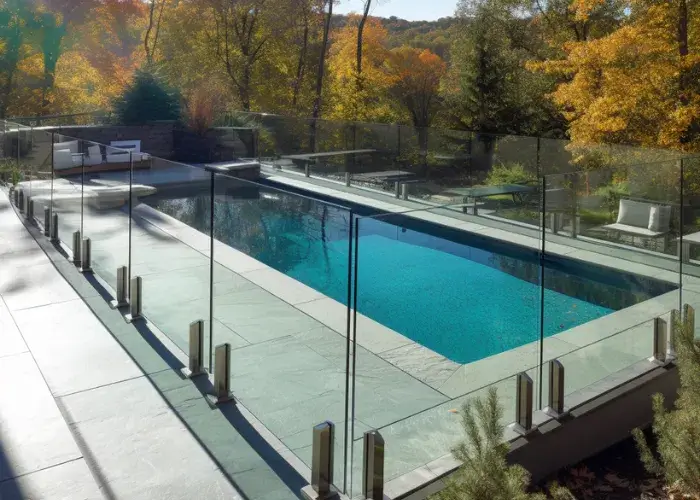 A backyard pool in Campbelltown surrounded with glass pool fence